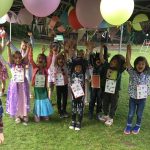 Students with their arms in the air