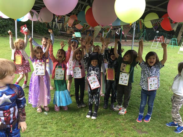 Students with their arms in the air