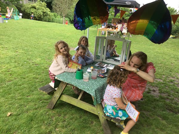 Students and teacher sitting around a picnic table