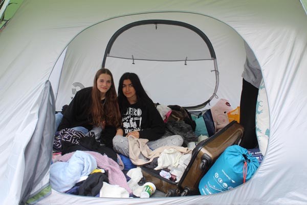 two students in a tent