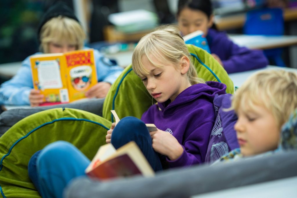 Year 3 student reading in class