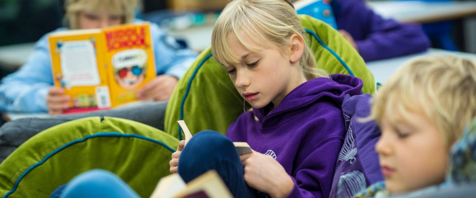 Year 3 student reading in class