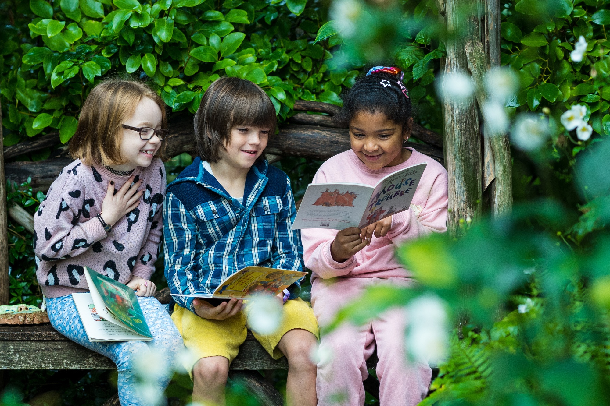 Year 3 students reading outdoors