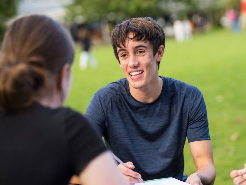 Sixth Form student studying on field