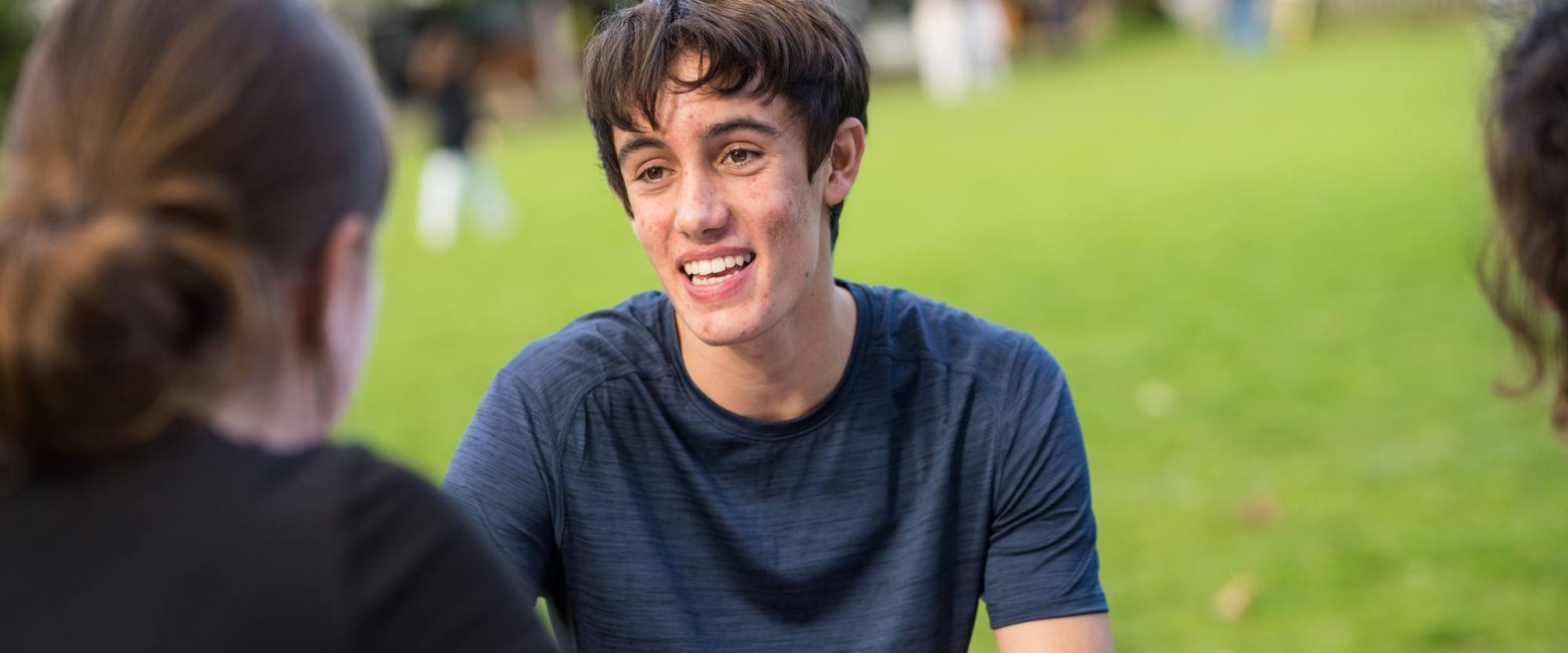 Sixth Form student studying on field