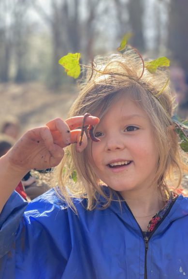 Forest school - student holding a worm