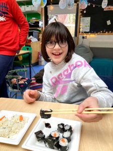 student eating sushi