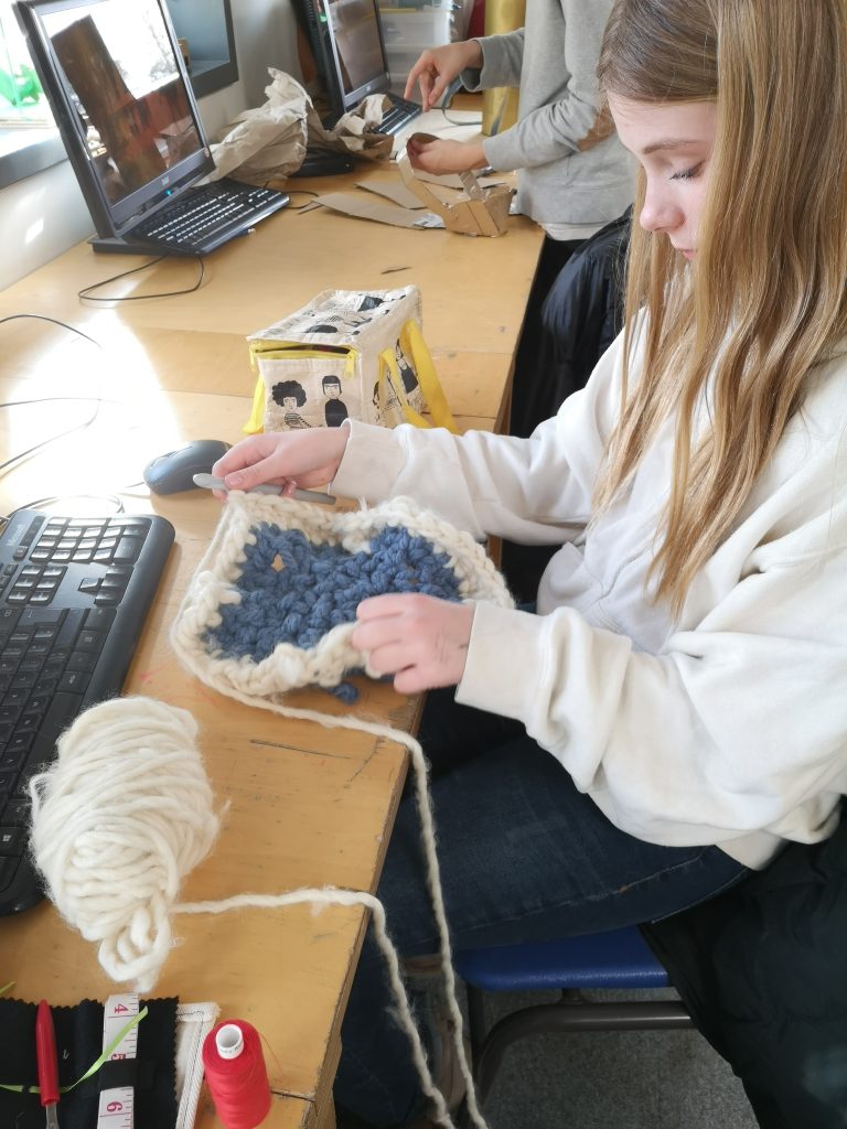 student crocheting 