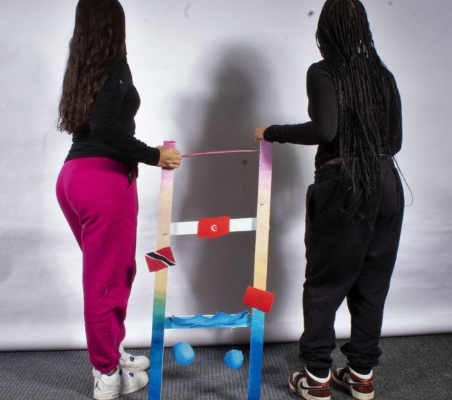 students holding a sculpture