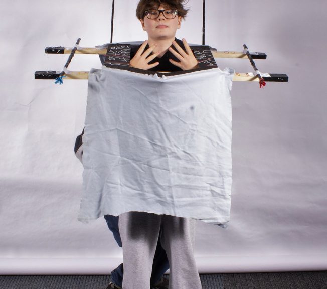 student showing his sculpture