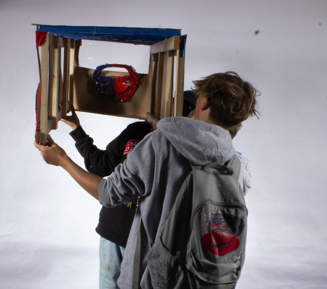 student holding a sculpture