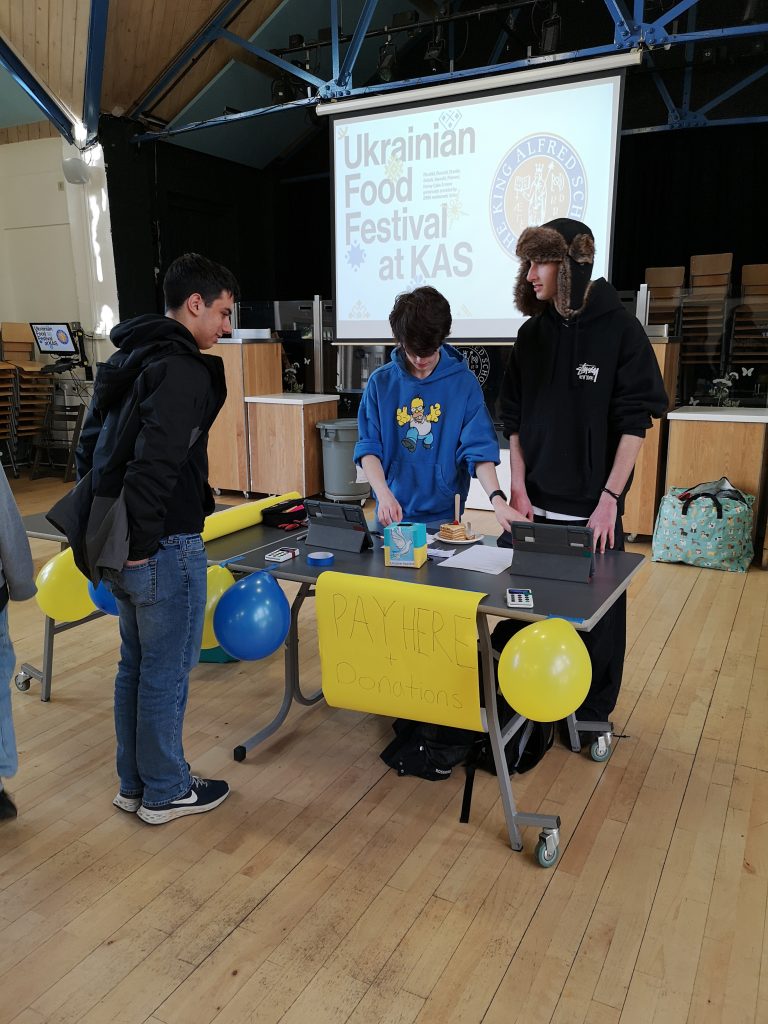 students selling Ukrainian food