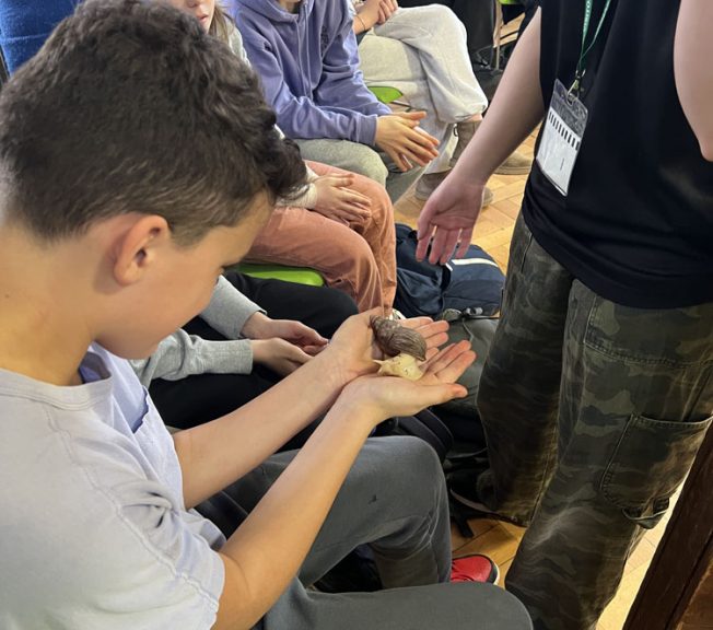 student holding a snail