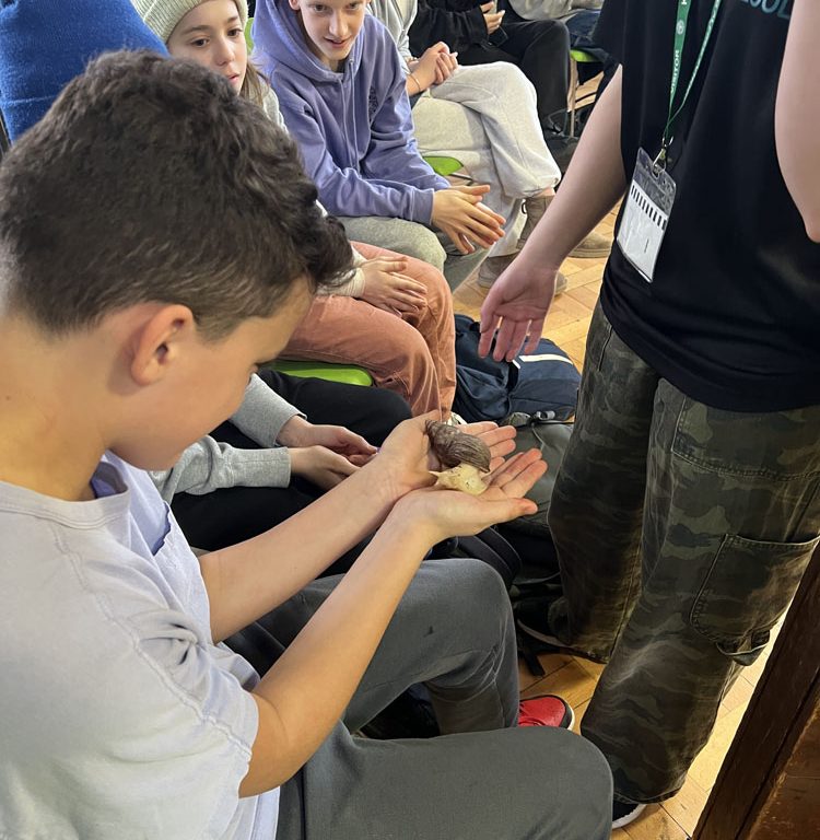 student holding a snail