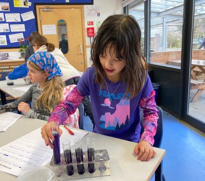 girl using test tubes