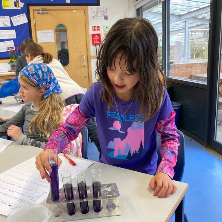 girl using test tubes