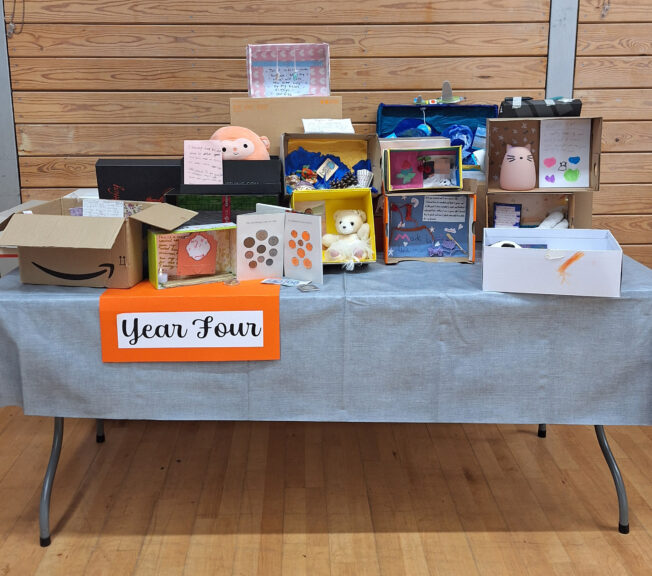 A table of individually decorated shoeboxes, with a sign that reads 'year four'