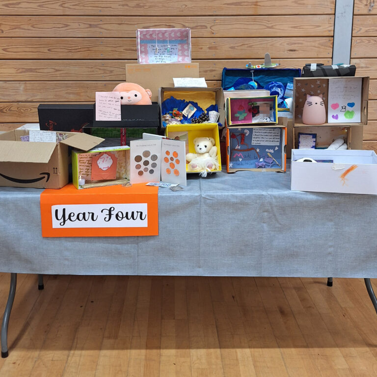 A table of individually decorated shoeboxes, with a sign that reads 'year four'