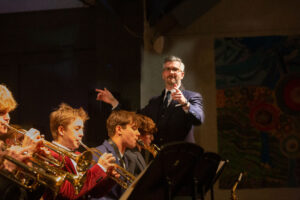 A teacher conducts the jazz band