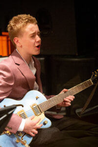 A student performs on the guitar as part of the Jazz evening