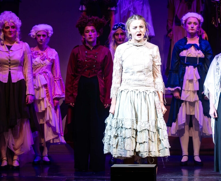 Ensemble of The Ballard of Raggedy Alice singing on stage