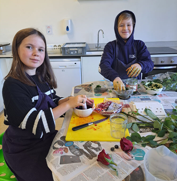 Two students making natural dyes