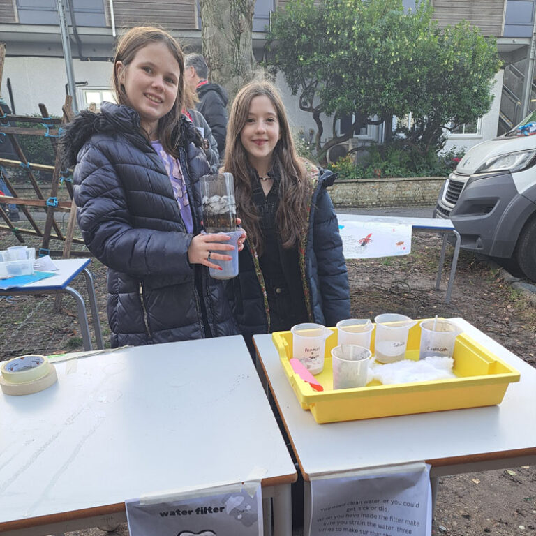 King Alfred School students with a water filter created using natural materials
