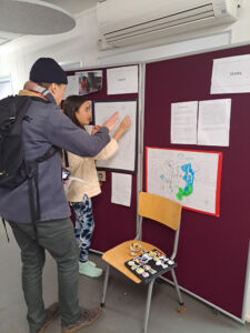 Parent and child looking at a display of the child's work during a Year 7 exploration at The King Alfred School, London