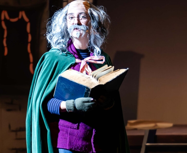 Actor dressed as the Storyteller in The Ballard of Raggedy Alice