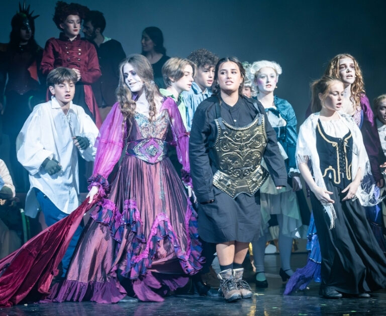 Ensemble of The Ballard of Raggedy Alice perform ons tage
