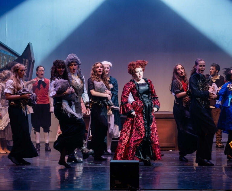 The cast of The Ballad of Raggedy Alice sing and dance on stage