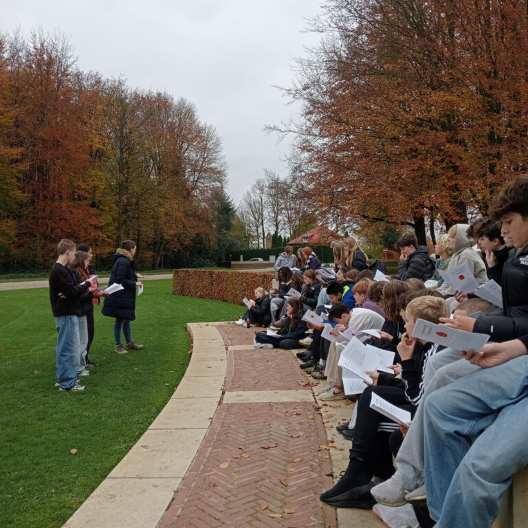 Students listening to WW1 poetry at a battlefield memorial