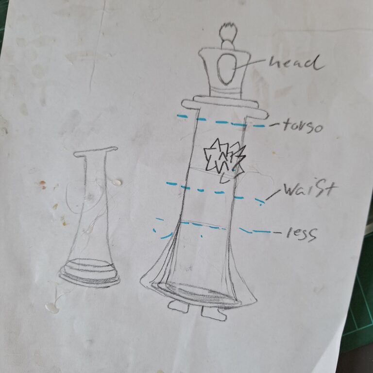 A pencil sketch showing the design for a wearable chess piece