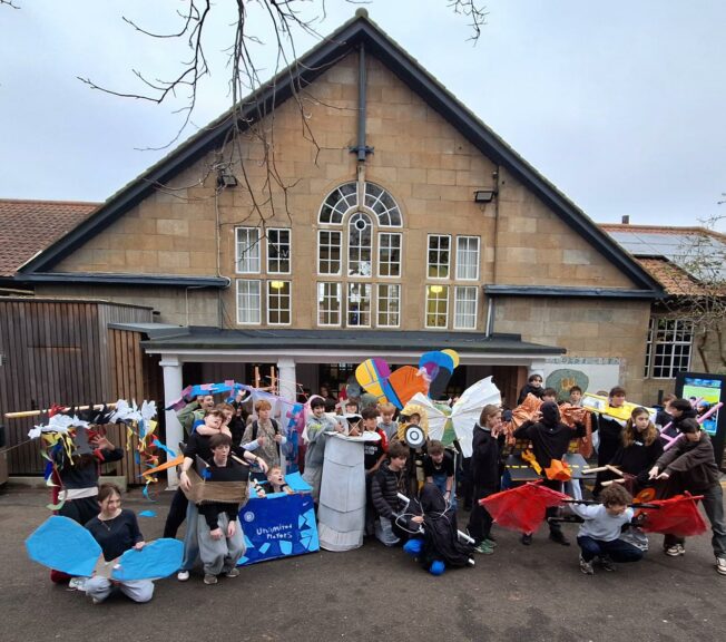 Group shot of Year 9 students at The King Alfred School wearing abstract art wearable sculptures