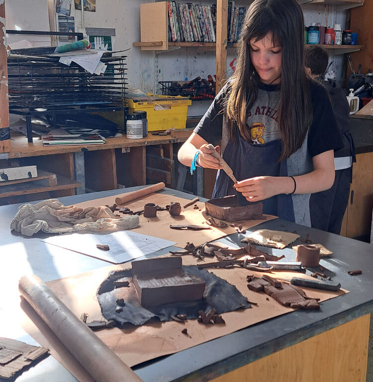 Students in the art room creating clay moulds at The King Alfred School North London