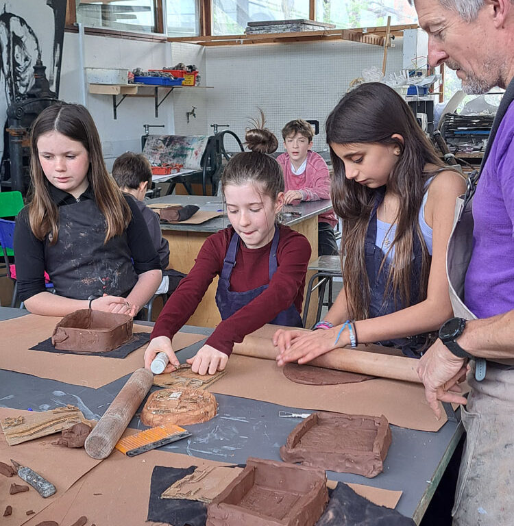 Students in the art room creating clay moulds at The King Alfred School North London