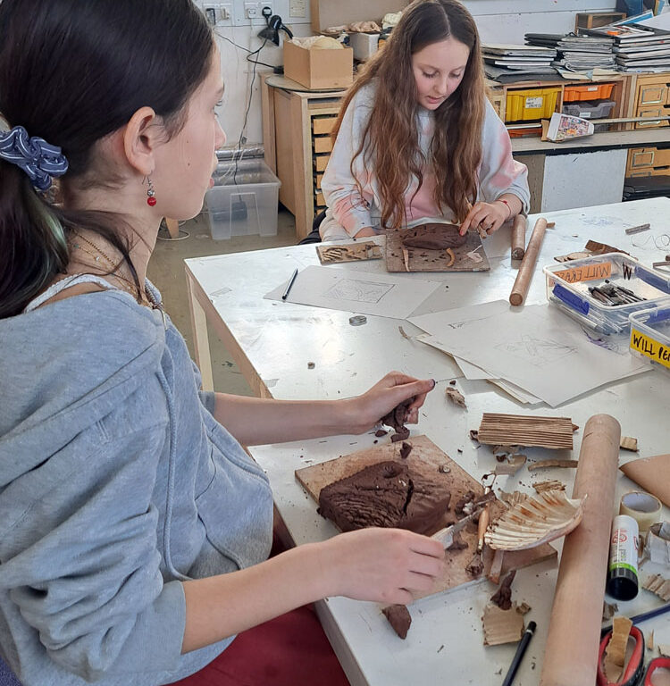 Students in the art room creating clay moulds at The King Alfred School North London