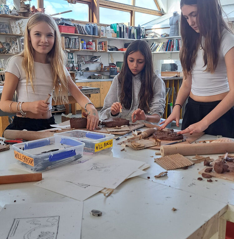 Students in the art room creating clay moulds at The King Alfred School North London