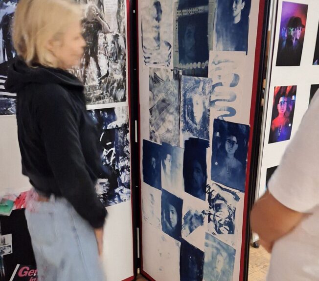 A female student looks at a photography display