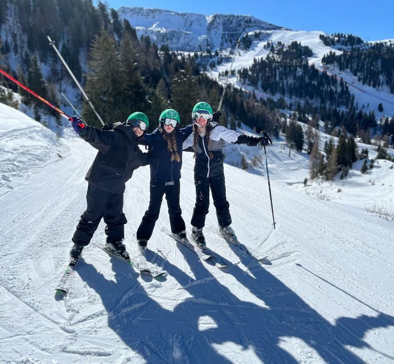 Students from The King Alfred School in North London pose whilst skiing on a snowy mountain in Italy