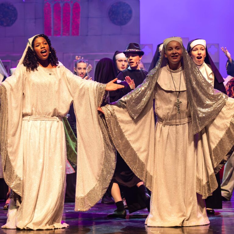 Students dressed as nuns perform on stage during The King Alfred School's performance of Sister Act Jr