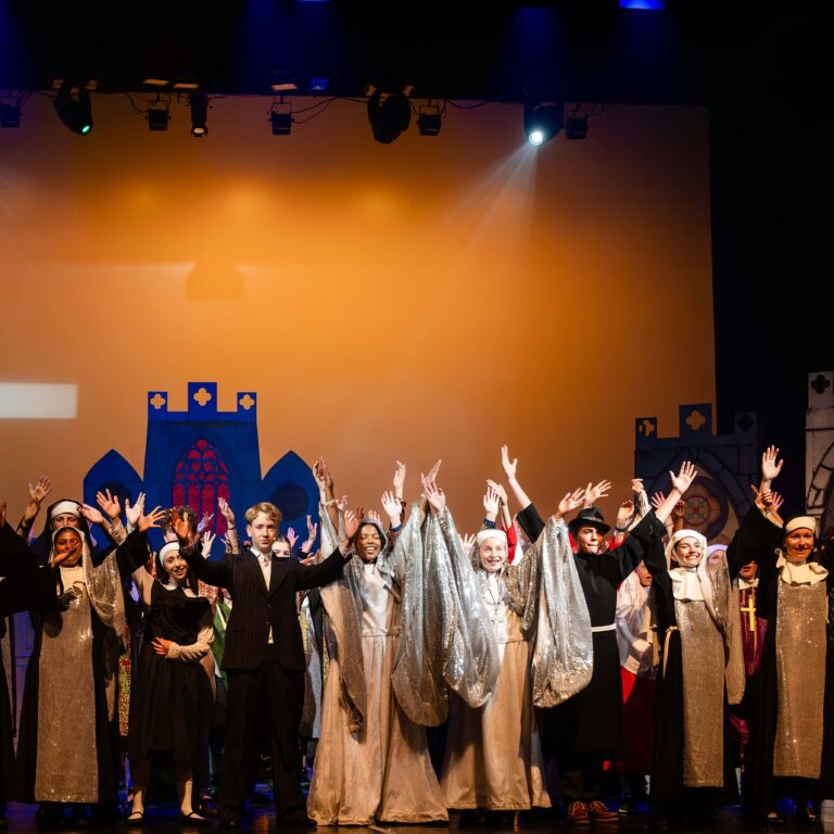 Students dressed as nuns perform on stage during The King Alfred School's performance of Sister Act Jr