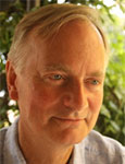 Headshot of a man with blonde hair parted to the side