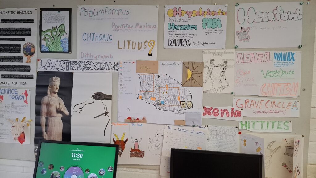 a selection of latin words illustrated and displayed on a school notice board