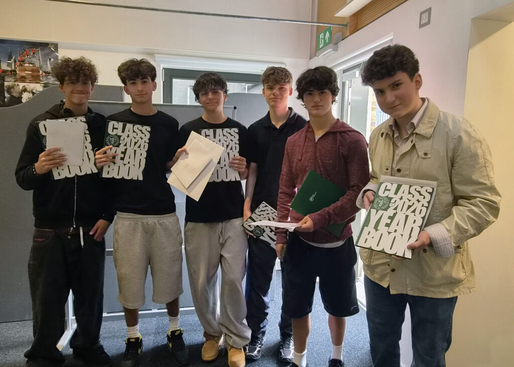 Six male Year 11 Students From The King Alfred School Pose With Their GCSE Exam Results And School Yearbooks